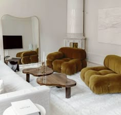 a living room filled with furniture and a flat screen tv on top of a wall