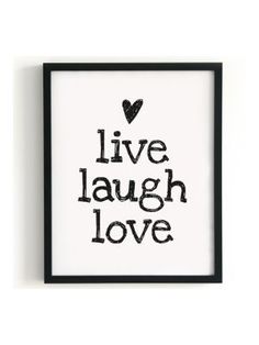 a framed black and white poster with the words live laugh love written in cursive font