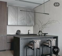 a kitchen with two stools and a counter top