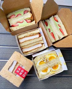 an open box with sandwiches and eggs in it