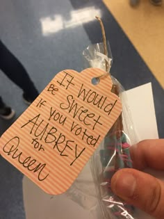 someone is holding up a candy bar wrapped in cellophane with writing on it