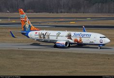 an airplane with dogs painted on the side is sitting on the runway and ready to take off