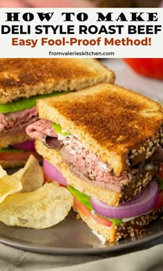 a roast beef sandwich cut in half on a plate with chips