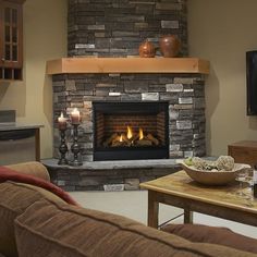 a living room filled with furniture and a fire place next to a flat screen tv