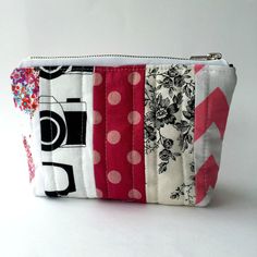 a small zippered pouch made out of fabric with flowers and polka dots on it