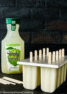 popsicles are lined up next to a bottle of milk