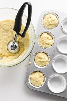 cupcake batter in a muffin tin next to an electric mixer