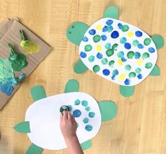 two children are making paper plates with sea animals