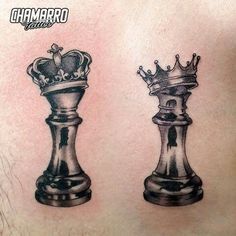 a man's chest with two chess pieces on it