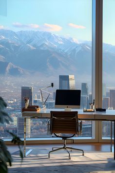 a desk with a computer on it in front of a large window overlooking the city