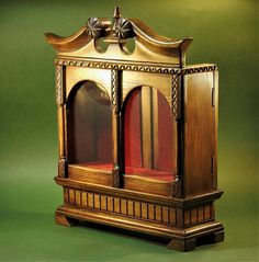 an antique wooden grandfather clock with red velvet seats