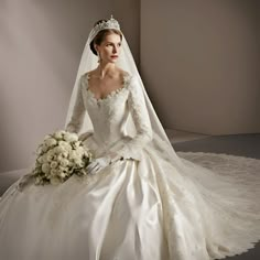 a woman in a wedding dress sitting down