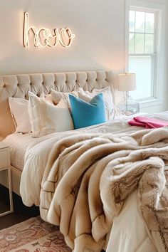 a bedroom with a large bed covered in blankets and pillows