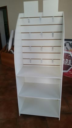 a white book shelf with several shelves on each side and numbered labels on the front