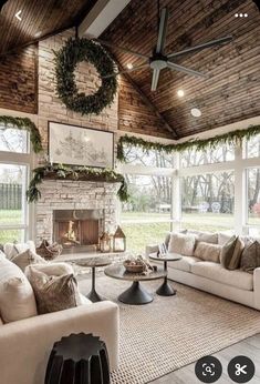 a living room filled with furniture and a fire place in the middle of an open floor plan