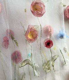 the fabric has flowers on it and is white