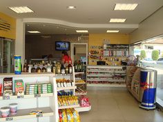 the inside of a grocery store filled with lots of food and drink bottles on shelves