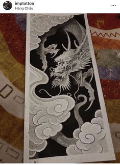 a drawing of a dragon with clouds in the background