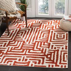 an orange and white area rug in a living room