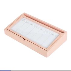 a pink box with a note pad in it