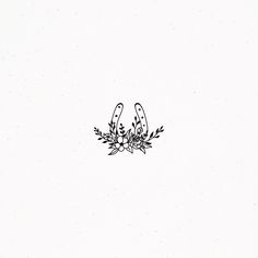 a black and white drawing of two scissors in the middle of some plants with leaves