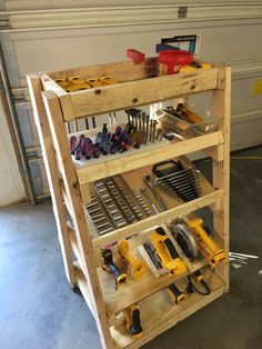 a wooden shelf filled with tools in a garage