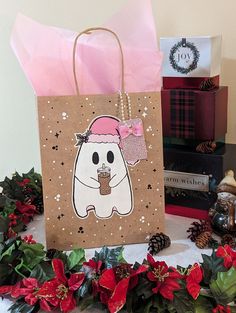 a brown paper bag with a white bear wearing a pink hat and holding a drink