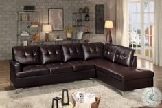 a brown leather sectional sofa sitting on top of a white rug in a living room