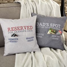 two pillows sitting on top of a couch with the words reserved for grandpa jack and remote here