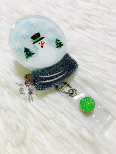 "PLEASE READ FULL DESCRIPTION BEFORE PURCHASING This listing is for a 2\" Snowglobe Badge Reel Holder. Acrylics are made of 1/8\" cast clear acrylic, high quality polyester glitter (color will not fade over time), and epoxy. Acrylics are permanently adhered to a clear swivel retractable alligator clip that extends to 35\". *Avoid prolonged exposure to high temperatures* *Avoid dropping from high points and from applying direct pressure**" Christmas Badge, Nurse Badge, Badge Holders Lanyard, Treat Bags, Badge Reel, Clear Acrylic, Alligator, Snow Globes