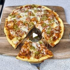 a pizza sitting on top of a wooden cutting board