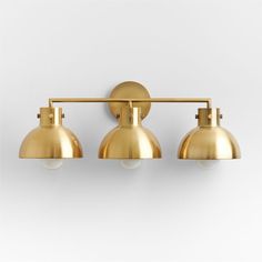 three light brass bathroom fixture with two bulbs on each side and one bulb off the wall