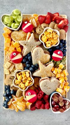 a platter filled with fruit, crackers and other snacks