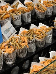 several baskets filled with fried food sitting on top of a table next to each other