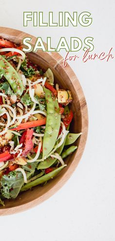 a salad in a wooden bowl with the title filling salads for lunch on top