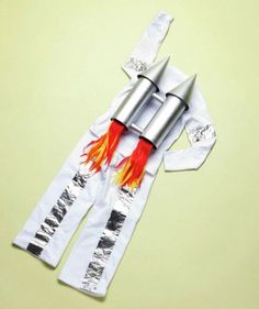 an image of a rocket ship costume made out of white paper with red and yellow flames on it