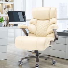 a white office chair sitting on top of a hard wood floor next to a computer desk