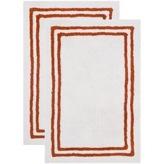 two orange and white rugs on top of each other, one with an orange border