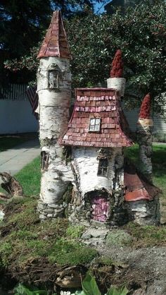 a fairy house made out of birch trees