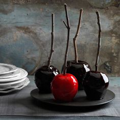 three pieces of chocolate covered apples on a plate