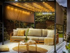 an outdoor living area with furniture and lights