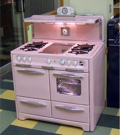 an old fashioned pink stove with two ovens