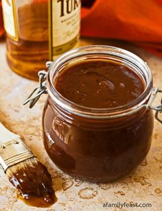 a jar of peanut butter next to a brush