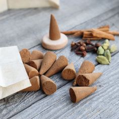 several cones, nuts and spices on a wooden table