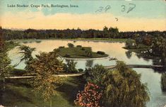 an old postcard shows a lake in the middle of a park, surrounded by trees