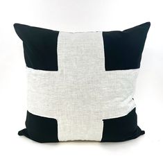 a black and white pillow on a white background