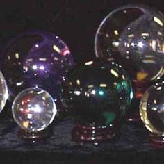 several shiny glass balls sitting on top of a table