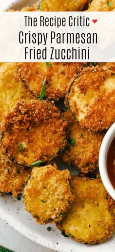 fried zucchini on a white plate with dipping sauce in the middle and text overlay that reads, the recipe critic crispy parmesan fried zucchini