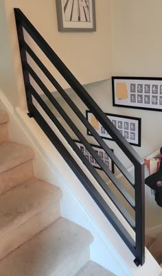 a woman sitting on top of a set of stairs next to a stair case in a house