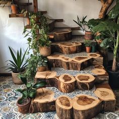 a set of wooden steps made out of tree slices and plants in pots on top of them